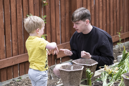 Student Teacher teaching a child SESE in the community garden